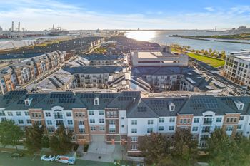 an aerial view of an apartment complex with a river in the background at Harbor Pointe, Bayonne, New Jersey